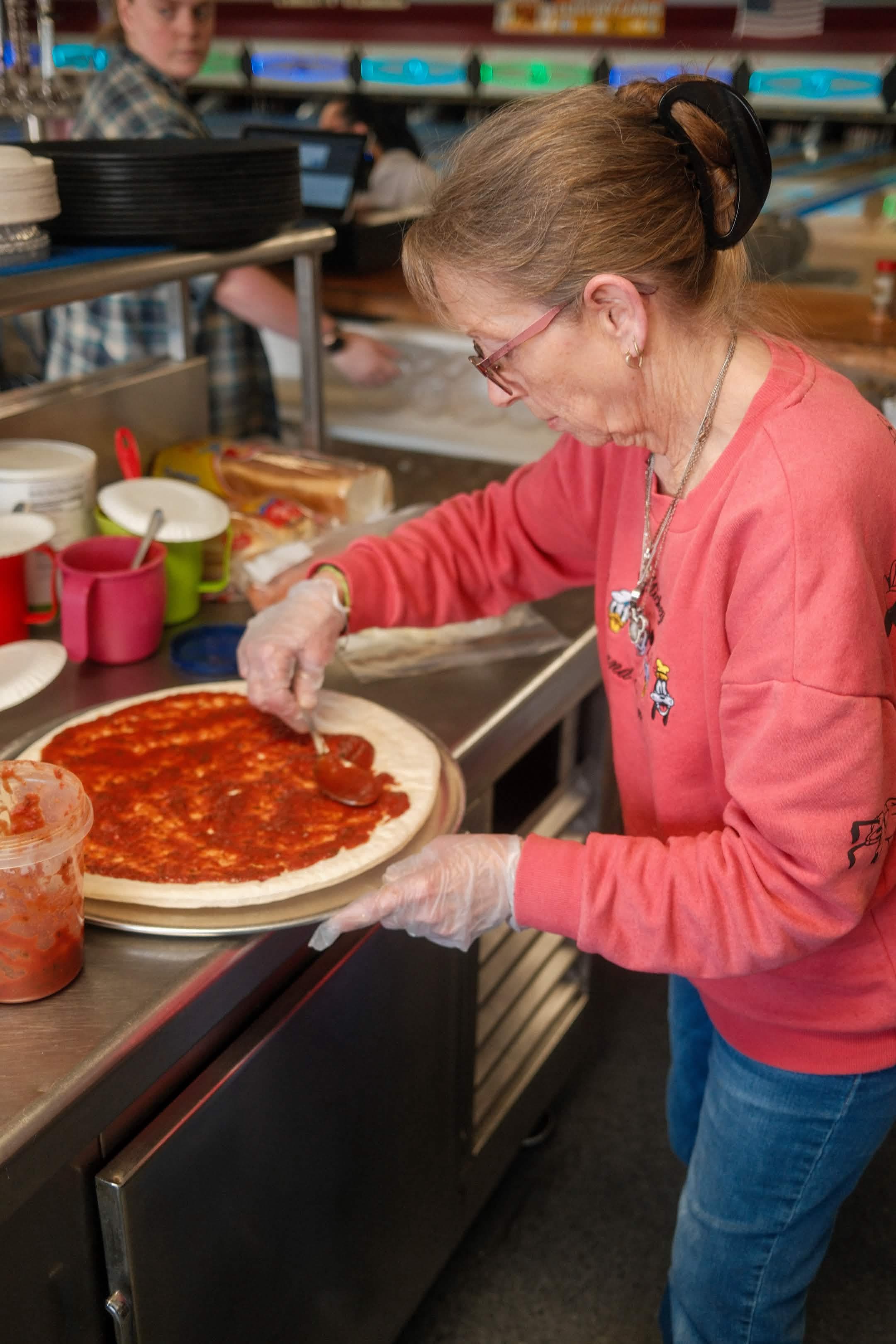 Snack bar staff making pizza